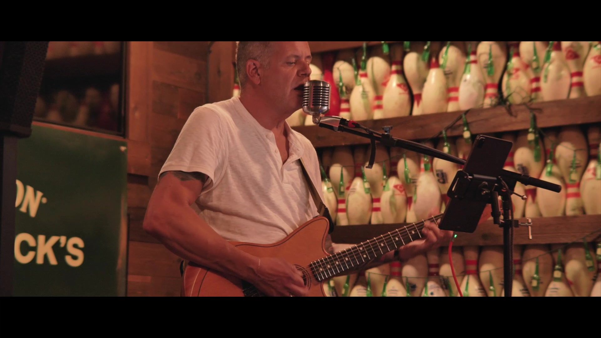 Mike Bush playing guitar and singing live